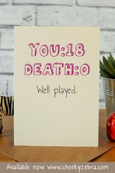 a card that says you're dead, well played next to a toy zebra