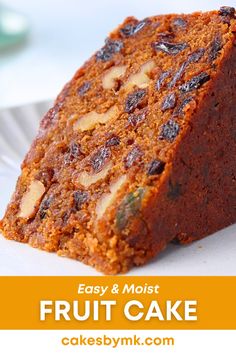 a close up of a piece of fruit cake on a plate with the words easy and moist