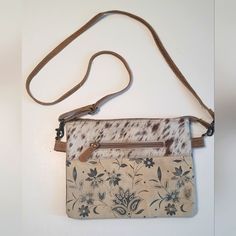 Myra S-1492 "Sanvitalia Crossbody Bag Canvas Floral Print Crossbody With Cowhide Leather On One Side. Black On The Other Side. Zippered Pockets On The Exterior Of Both Side And A Divided Center To Give You Two Sections Inside. Measures Approx: 10"X8". Looks Brand New Inside. Cream Pouch Bag With Adjustable Strap, Cream Pouch Shoulder Bag For Daily Use, Cream Shoulder Pouch Bag For Daily Use, Daily Use Cream Shoulder Pouch Bag, Cream Pouch Bag With Leather Handles, Cream Clutch Bag With Adjustable Strap, Cream Shoulder Bag Pouch For Everyday Use, Casual Cream Clutch Bag, Cream Satchel Pouch With Mobile Phone Bag