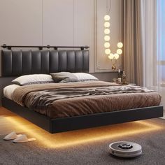 a bed with lights on the headboard and foot board is shown in this modern bedroom