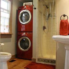 a red washer and dryer in a bathroom