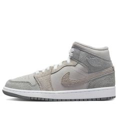 Step into the Air Jordan 1 Mid SE Particle Grey for an unforgettable classic. This sneaker is crafted with supple suede throughout its upper, featuring a grey nubuck and fluffy suede overlays. Its inner lining is made of white fleece that adds comfort to your steps. The sneaker is finished off with a White midsole and Grey outsole, completing a timeless design that you'll love for years to come. Jordan Aj 1 Mid, Air Jordan Mid, Air Jordan 1 Shoes, Jordan 1 Shoes, Wmns Air Jordan 1, Air Jordan 1 Mid Se, White Fleece, Women's Basketball, Mid Top