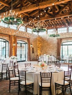 an indoor venue with tables and chairs set up for a wedding reception at the lodge