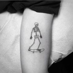 a skeleton riding a skateboard on the arm