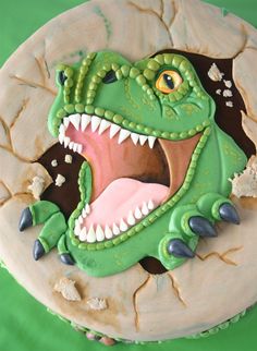 a cake decorated to look like a dinosaur with its mouth open