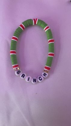 a green and red beaded bracelet with the word prince on it's side