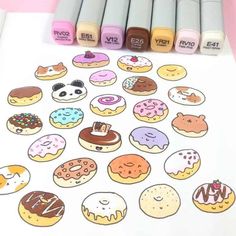 several different colored donuts and crayons on a sheet of paper with markers