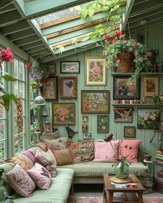 a living room filled with lots of furniture and pictures on the wall above it's windows