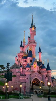 the pink castle is lit up at night