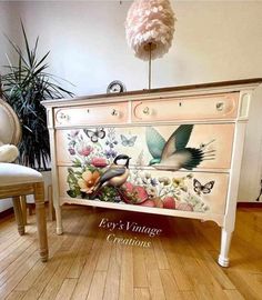 an old dresser painted with birds and flowers