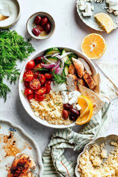 a table topped with plates and bowls filled with different types of food next to utensils