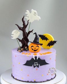 a cake decorated with halloween decorations and bats