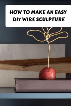 an apple sitting on top of books with the title how to make an easy diy wire sculpture