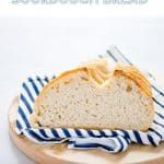 a loaf of bread on a plate with blue and white striped napkins next to it