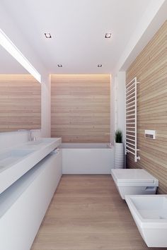 a modern bathroom with wood paneling and white fixtures