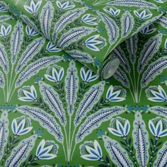 a green and blue wallpaper with leaves on it