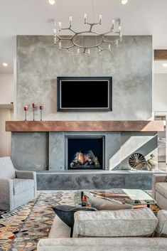 a living room with a fire place, couches and a television mounted on the wall