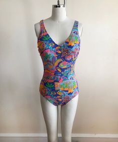 Brightly colored fish print swimsuit/bodysuit, from the 1980s. Bust measures 17.5" (44.5 cm) flat across, waist measures 12.5" (32 cm) flat across, and hip measures 15" (38 cm) flat across. The swimsuit is 27.5" (70 cm) long. Original size is a 10. Cotton/spandex blend. Retro Print Swimwear For Summer Beach, Retro Blue Printed Swimwear, Retro Print Swimwear For Beach In Summer, Fitted Retro Print Swimwear For Beach, Summer Beach Swimwear With Retro Print, Fitted Retro Print Beachwear Swimwear, Retro Printed Swimwear For Beach Season, Retro Print Swimwear For Beach Season, Retro Print Swimwear For Beach Season Vacation