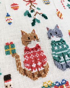 a cross stitch pattern with cats and christmas decorations