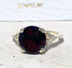 Don't miss this opportunity to own this beautiful gemstone ring crafted in 14k gold filled => Gemstone Type - Garnet, Clear Quartz => Gemstone Cut - Faceted => Gemstone Size - 10 mm, 2 mm => Total Number of Gemstones - 7 => Metal Type - 14k Gold Filled (Tarnish Resistant And Nickel Free) - also available in 925 sterling silver * Please contact me for pricing on a sizes larger than 11 * ~ Feel free to ask me about custom made designs. ❏ Replacements and custom orders : ✪ 925 sterling silver - no Yellow Gold Garnet Rings With Prong Setting, Garnet Rings With Prong Setting In Fine Jewelry Style, Fine Jewelry Round Cluster Ring With Garnet, Fine Jewelry Garnet Ring With Prong Setting, Fine Jewelry Garnet Cluster Ring, Formal Rings With Round Gemstone Accents, Round Ruby Ring With Accent Stones For Gift, Formal Garnet Rings With Gemstone Accents, Yellow Gold Topaz Ring With Gemstone Accents