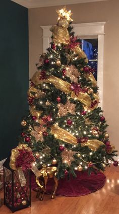 a christmas tree with gold and red decorations