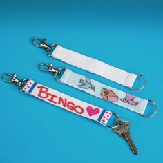 two keychains with different designs on them