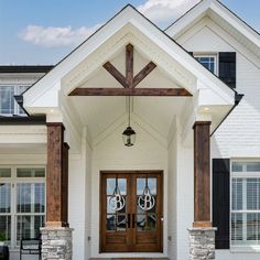 the front entrance to a house with two double doors and an entry way leading into it