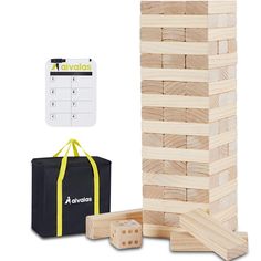 a wooden block tower next to a black bag