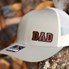 Custom Richardson 112 Trucker style snapback hats make great gifts for new dads, new grandfathers, birthdays, Valentine's Day, Father's Day and of course, Christmas! Our genuine leather patches are laser engraved and laser cut to your custom specifications and applied to Richardson 112 Trucker style caps. You choose the personalization and the color of the cap you would like. Richardson 112 Adjustable Snapback Trucker Cap: - 60/40 cotton/polyester - 100% polyester mesh back - Structured, six-pan Adjustable Snapback Hat For Father's Day, Outdoor Trucker Hat For Father's Day, Father's Day Trucker Hat For Outdoor, Adjustable Flat Bill Snapback Hat For Father's Day, Father's Day Gift Snapback Hat With Curved Brim, Father's Day Gift Trucker Hat With Curved Brim, Father's Day Outdoor Trucker Hat, Curved Brim Baseball Cap For Father's Day, Adjustable Hats As Father's Day Gifts