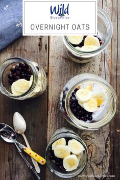 three jars filled with fruit and yogurt on top of a wooden table