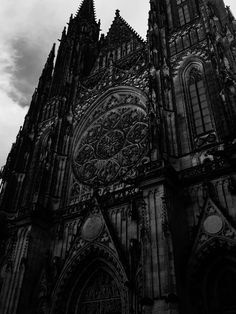 black and white photograph of an old cathedral with ornate carvings on it's side