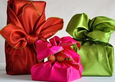 three different colored wrapped presents sitting on top of each other