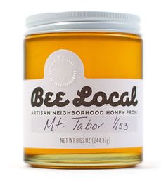 a jar of honey sitting on top of a white table