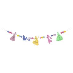 an image of a garland with princesses and beads hanging from the side on a white background