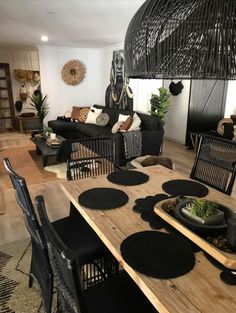 a dining room table with black chairs around it and an area rug on the floor