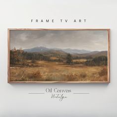 an oil painting hanging on the wall above it is a landscape with mountains in the distance