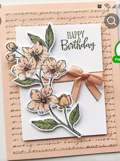 a close up of a greeting card with flowers on it and a ribbon around the edge