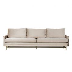 a white couch sitting on top of a metal frame