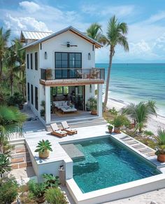 an aerial view of a house with a pool in the foreground and ocean in the background