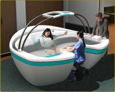 two people are playing in an interactive bathtub that is designed to look like a boat