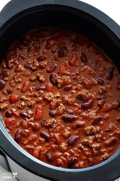 a slow cooker filled with chili beans and ground beef is ready to be eaten