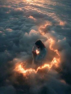 a woman sitting in the clouds with her hands on her knees