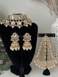 uncut kundan pearl choker  With jhumki  and tikka and passa.  available in 7 colors  Lightweight earrings  Style tip- ----------- Pair it with any beautiful traditional outfits  and flaunt with Unique style of collection from us. Perfect match for Festival and Traditional wear.  Take Care Tips-  ---------------- Kee away from perfume, Hair spray and. Moisture.  Store in dry place , Ziplock bag or Airtight box.    Clean with dry cloth.  Jewellery is the last thing you should wear and first thing Temple Jewelry With Mirror Work For Eid, Heavy Kundan Jewelry For Eid, Eid Wedding Jewelry With Mirror Work, Kundan Jewelry For Eid, Bollywood Kundan Jewelry For Eid, Kundan Jewelry With Mirror Work For Wedding, Bollywood Jewelry With Mirror Work For Eid, Bollywood Style Jewelry With Mirror Work For Eid, Eid Bollywood Jewelry With Mirror Work