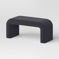 a black bench sitting on top of a white floor