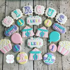 decorated cookies are arranged in the shape of baby's first birthdays and numbers