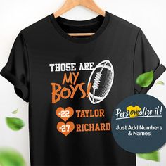 a t - shirt with the words those are my boys and two heart shaped footballs