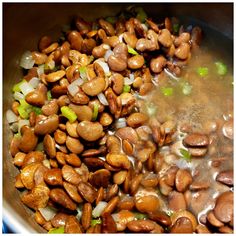 beans and onions cooking in a pot on the stove