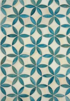 an artistic tile design in shades of blue and white, with circular leaves on it