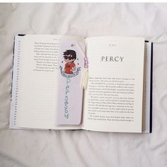 an open book with a cartoon character on the front and back cover is laying on a bed