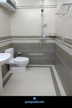 a white toilet sitting in a bathroom next to a sink